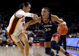 UConn player dribbling past defender