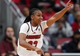 Female basketball player in white jersey pointing